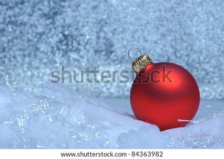 Christmas red sphere. Bokeh background blue toned