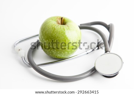 Protect your health with healthy nutrition: Stethoscope and apple