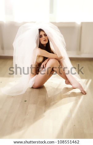 a beautiful young girl with long hair and veil