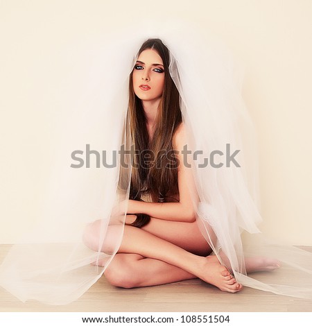 a beautiful young girl with long hair and veil