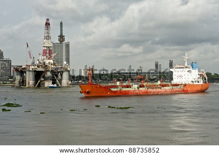 Ship with oil rig in the background in the Nigerian capitol Lagos