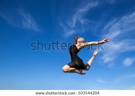 Freedom concept. Dancer jumping against blue sky (1)