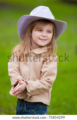 sweet smiling cowgirl in a park