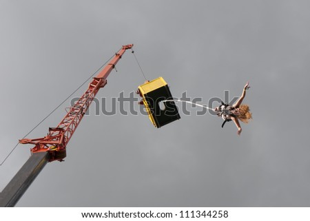 JAROCIN, POLAND - JUNE 22: An unidentified naked fan of rock and punk music jumps on bungee at Jarocin Festival in Poland on June 21, 2012 in Jarocin in Poland