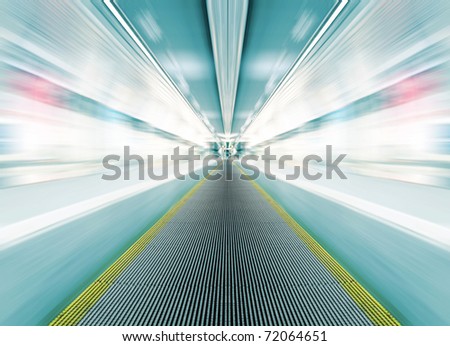 metro escalator in glass corridor