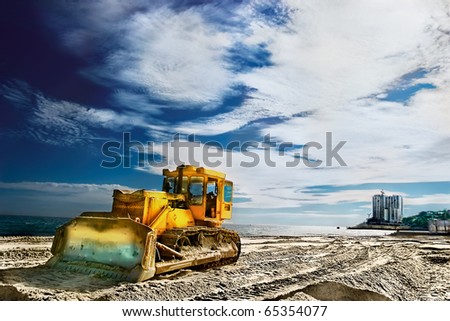 Tractor on a sandy beach near the sea