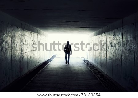silhouette in a subway tunnel. Light at End of Tunnel
