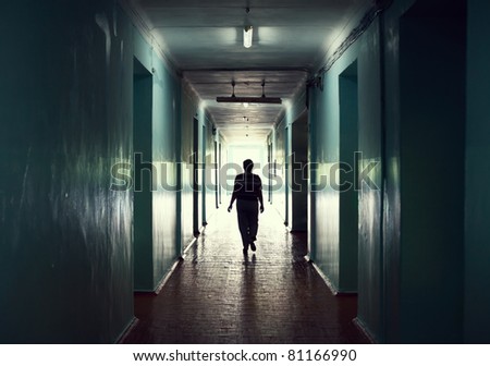 silhouette in a corridor. Light at the end of the tunnel concept