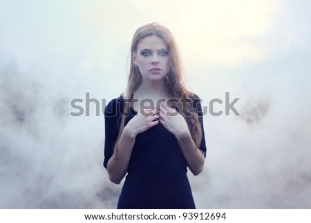sensual beautiful girl in white smoke on nature