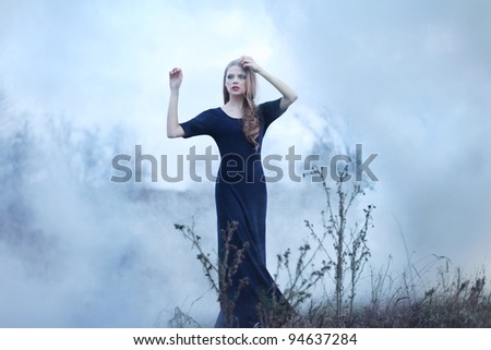 sensual beautiful girl in smoke on nature