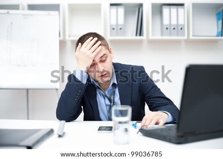 Thoughtful or stressful businessman at work