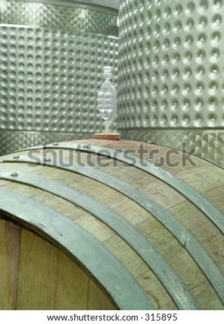 A winery shows the wooden barrel and modern vats.  Atop the barrel is a CO2 vent.  (14MP camera)