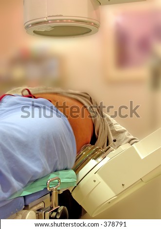 A real lithotripter (kidney stone blaster). A doctor uses fluoroscopy (above the patient) to view the progress. The stones are broken up by shockwaves from below the patient.