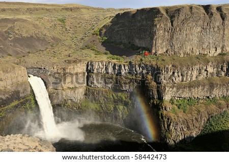 This is the 200 foot waterfall in Palouse Falls State Park with a real rainbow and helicopter flying low.