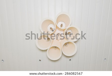 Modern designer lamp on a white ceiling