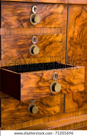 wooden cabinet with drawer, beautifully textured with keyholes and handles