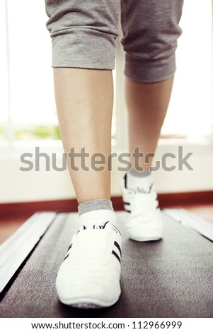 Runner feet running on running track, woman fitness