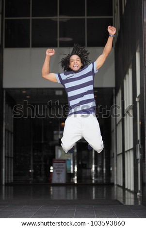 Happy black man jumping for joy