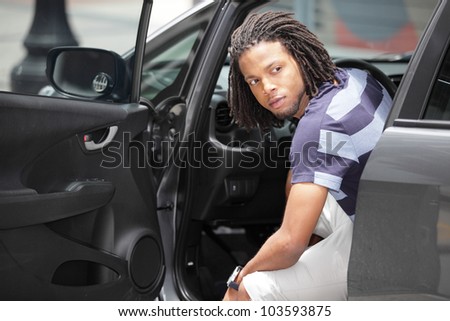 Man looking behind his car