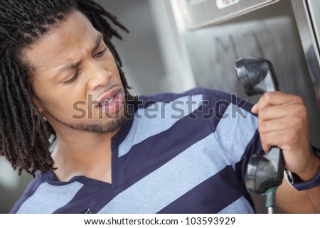 Man expressing anger at the telephone