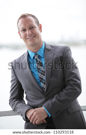 Businessman leaning on a rail