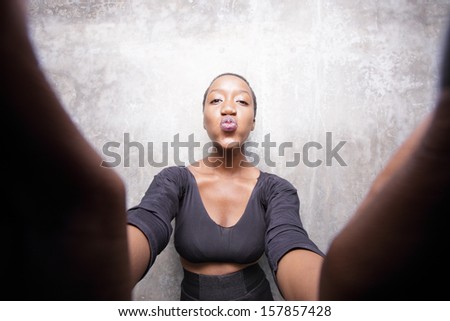 Woman reaching and kissing the camera