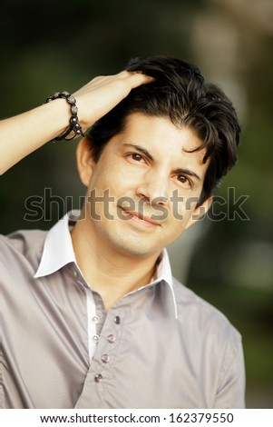 Stock image of a man with hand on head
