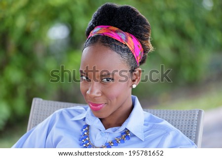 Head shot of a beautiful Jamaicn woman smiling