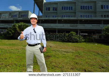 Stock image of a construction professional showing a thumbs up gesture
