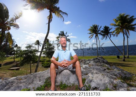 Stock image of a old man sitting on a rock