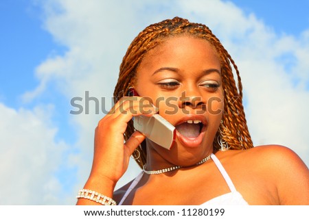 Woman talking on the phone displaying a shocking expression