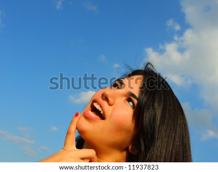 Woman on blue sky. Expressing confusion.
