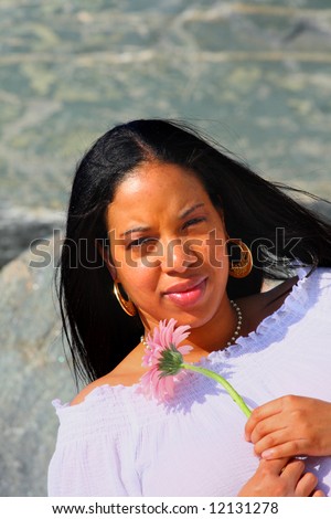 Young black woman with a flower