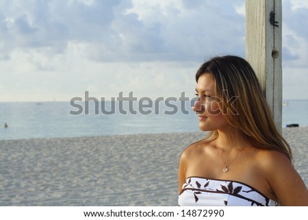 Head and Shoulders Shot of a Woman Looking Out At The Ocean