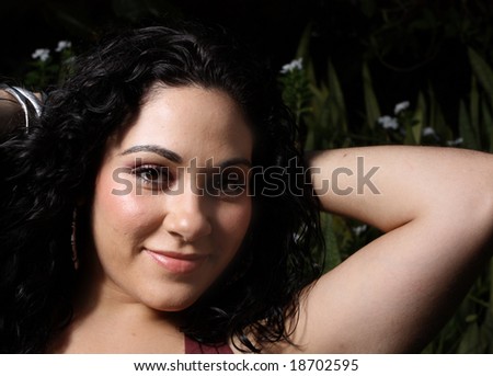 Woman with arm behind her head