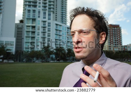 Man holding a cigarette and talking to himself