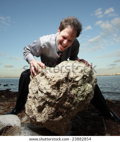 Man rolling a big rock