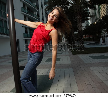 Woman hanging from a pole