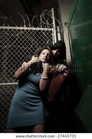 Woman being choked in a dark alley by a thug