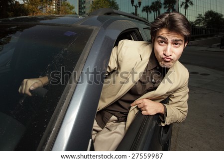 Man driving with his head out of the window