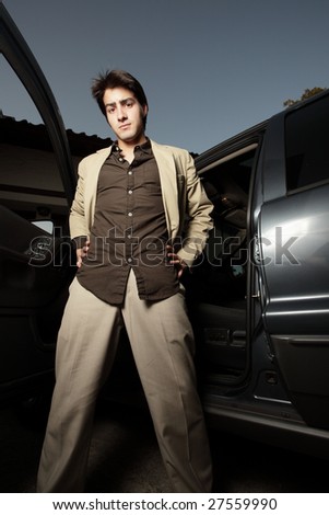 Man standing next to his vehicle with the door open