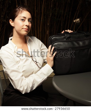 Young woman with her laptop bag on the table