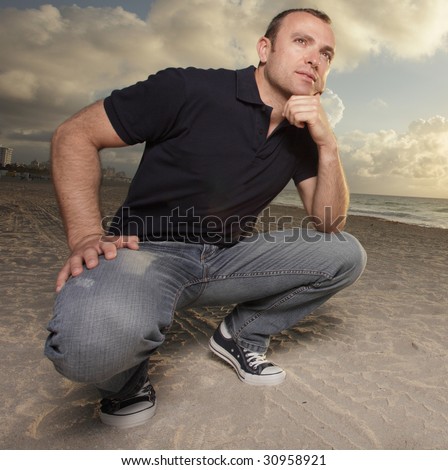 stock-photo-man-squatting-on-the-sand-30958921.jpg