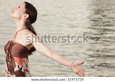 Woman with arms extended behind her