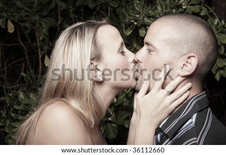 Young female kissing her man