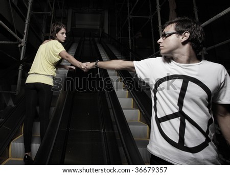 Man and woman going in opposite direction and trying to hold on