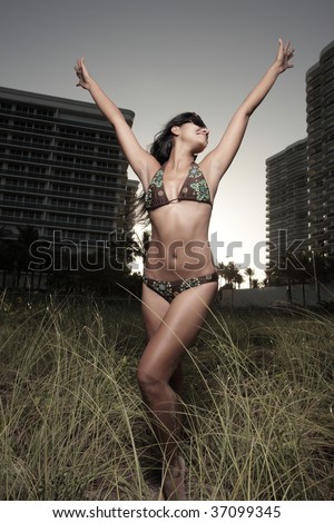 Woman in a bikini with arms extended outward