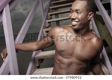 Man smiling on a lifeguard stand