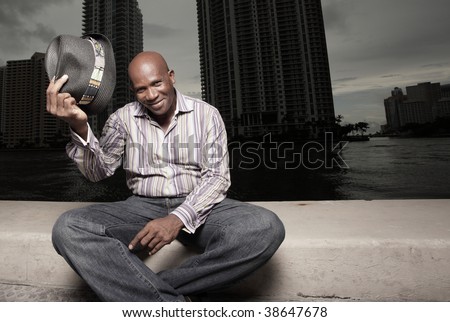 Smiling man tipping his hat