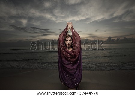 Woman covering herself with a purple veil